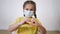 face child protective mask shows a gesture heart. stay home coronavirus quarantine kid dream concept. protection little