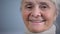 Face close-up of smiling elderly woman, social security, taking care in old age