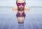 Face closeup of woman in purple sunglasses in infinity rooftop swimming pool