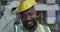 Face, construction site or happy black man with hardhat, smile or pride for architecture or building. Engineering