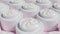 Face cream in white jars moves. Cosmetic products for makeup and skincare.