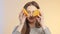 Face of cute girl grimacing with halfs of orange fruit in hands, teenager having fun and positive mood on studio background, conce