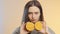 Face of cute girl grimacing with halfs of orange fruit in hands, teenager having fun and positive mood on studio background, conce