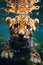 face of a cute tiger leopard cub is diving above the surface of the river water