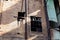 Face of a derelict brick industrial building, rusted metal exterior structures, broken windows and aged green fiberglass