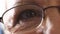 Face details of a retired man thinking of happy, nostalgic memories. Senior man wearing eyeglasses. Closeup of one old