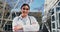 Face, doctor and woman with arms crossed, smile and outdoor with pride for career, sunshine and lab coat. Portrait