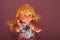 On the face of the doll the light shines,little doll at night glows with beautiful golden hair