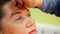 Face elderly woman while eyebrows makeup in beauty studio close up