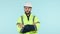 Face, engineer and man with arms crossed in helmet at studio isolated on a blue background mockup space. Portrait