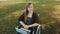 Face expression of young caucasian disabled woman in the wheelchair with laptop in the park