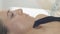 Face and fingers of girl lie under blanket in beauty saloon. Girl on procedures