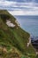 A face formed by chalk cliff and grass in Etretat, Normandy, france