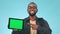Face, green screen and black man with a tablet, okay sign or connection on a blue studio background. Portrait, African