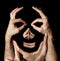 Face hands concept. Realty manipulation illusion. Black background