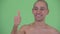 Face of happy bald multi ethnic shirtless man giving thumbs up