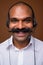 Face of happy Indian businessman with mustache as call center representative