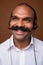 Face of happy Indian businessman with mustache as call center representative