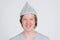 Face of happy young man with tinfoil hat as conspiracy theory concept