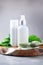 Face jade roller massager, nettle lotion, cream, shampoo in white bottles and nettles leaves. Medicinal herb for beauty, skin care