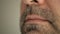 Face, lips of a man with a gray beard. Super macro close-up.