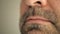 Face, lips of a man with a gray beard. Super macro close-up.