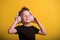 Face of little boy who is concentrated isolated over yellow background. Kid with closed eyes is listening music with