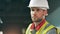 Face of a male industrial worker wearing a hardhat