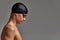 Face of a man swimmer close-up, gray background, copy space, young guy swimmer in a mask and swimming cap