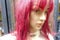 Face of a mannequin with colorful pink hair