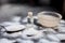 Face mask or face pack of baking soda in a glass bowl on wooden surface along with powder and some coconut oil in a transparent