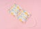 Face mask flower pattern on light pink background