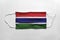 Face mask with Gambia flag printed, on white background, isolated
