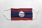 Face mask with Laos flag printed, on white background, isolated