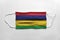 Face mask with Mauritius flag printed, on white background, isolated