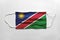 Face mask with Namibia flag printed, on white background, isolated