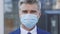 Face of Mature Caucasian Handsome Manager in Medical Mask While Pandemic, Looking Straight to Camera with Happy Look