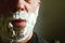 Face of mature man with white shaving cream