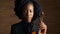Face, music and violin with black woman artist in studio on wooden wall background for orchestra performance. Portrait