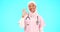 Face, nurse and Muslim woman with ok sign in studio isolated on blue background mockup. Smile, portrait and happy