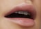 Face part. Beautiful female lips with natural makeup, clean skin. Macro shot of female lip, clean skin. Fresh kiss. Spa beauty cos