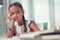 Face portrait of Afro-American schoolchild spending time doing boring homework.