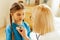 Face portrait of girl standing quietly amid pediatrician examining lungs