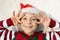 face portrait of smiling joyful cute child in Santa hat and elf sweater, numbers of new year 2024