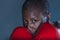 Face portrait of young angry and defiant black afro American sport woman in boxing gloves training and posing as a dangerous figh