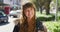 Face portrait of a young beautiful woman, student smiling. Closeup of pretty Caucasian girl standing in the city street