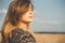 Face profile of romantic young woman enjoying sunset on wheat field, girl breathe breathes deeply , freedom and relaxation concept