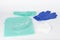 Face respirator mask, plastic protective eyglasses, protective gown, cap, pair of gloves,  personal protective equipment to