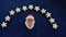 Face of Santa Claus under a garland of home-baked cinnamon stars. Close-up,  against a blue background