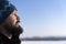 Face of Scandinavian bearded man in profile. Bearded man squints from the sun